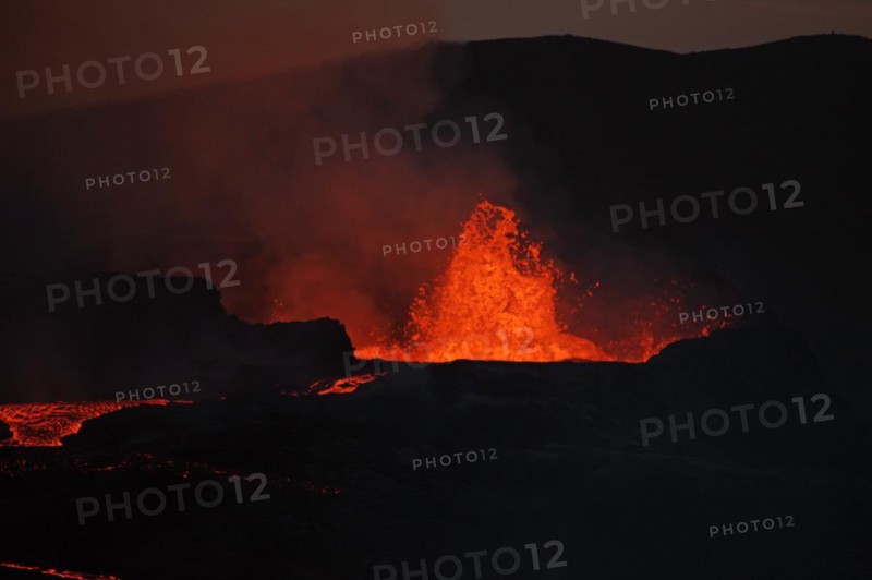 Active volcano spewing lava into the sky
