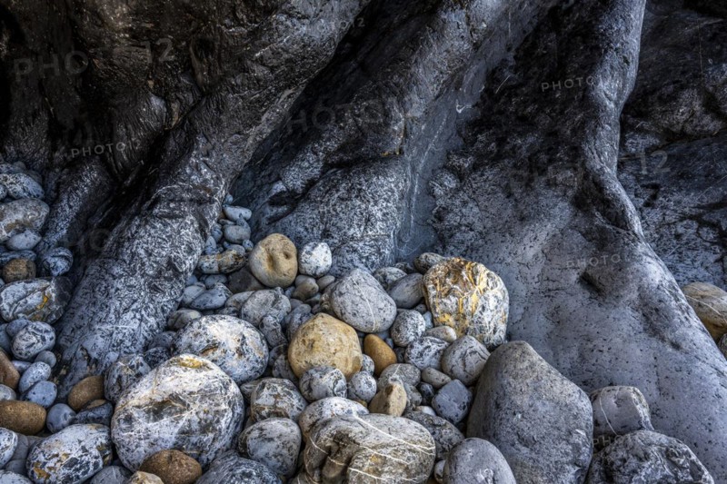 Rocky coast and colourful stones at Praia da Adraga