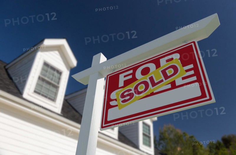 Sold for sale real estate sign in front of new house