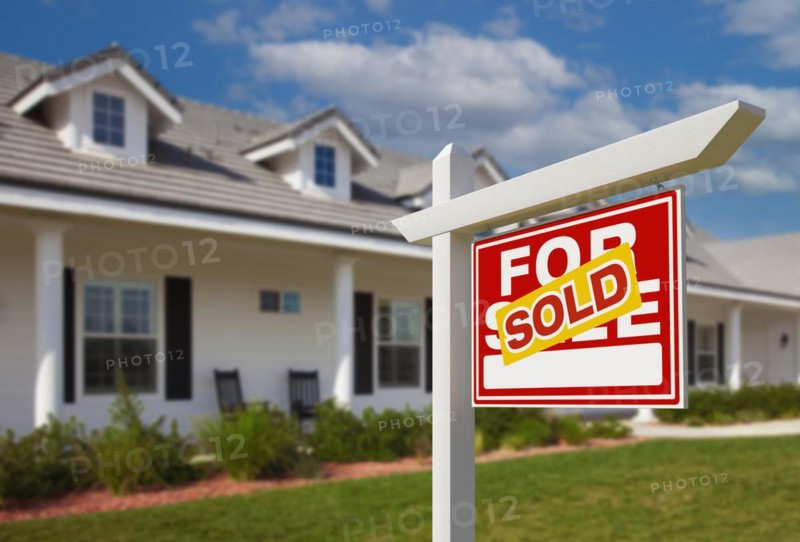 Sold for sale real estate sign in front of new house