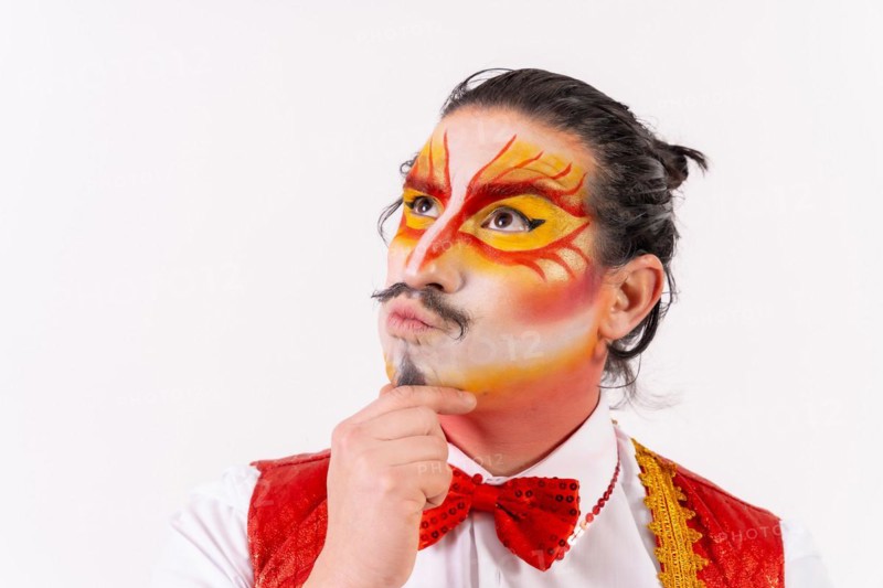 Portrait of smiling juggler with painted clown face isolated on white background