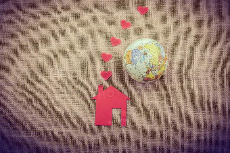 Heart shape coming out of chimney of paper house