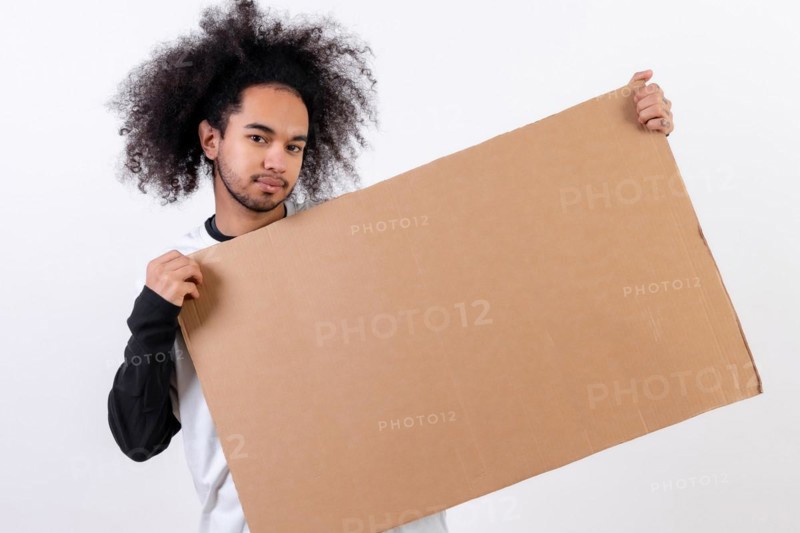 Holding a sign with copy paste space. Young man with afro hair on white background