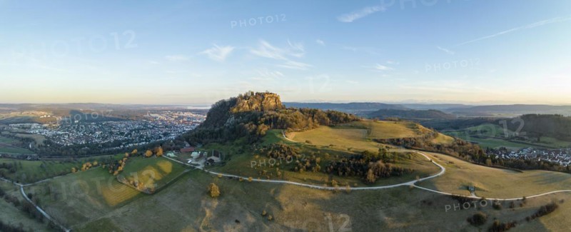 Panorama of the volcanic cone Hohentwiel with the castle ruins illuminated by the evening sun