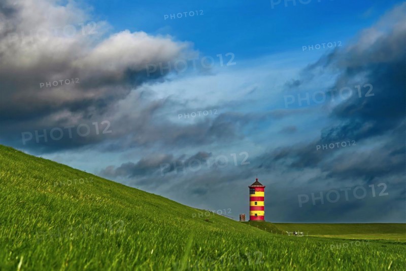 Pilsum lighthouse on the dyke near Greetsiel in the Krummhoern region on the East Frisian North Sea coast