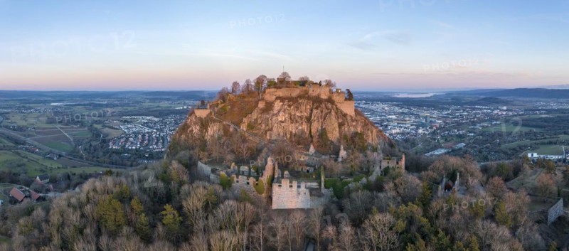 Panorama of the volcanic cone Hohentwiel with the castle ruins illuminated by the evening sun