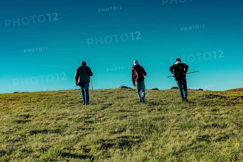 Hikers with backpacks and trekking poles walking in Turkish highland