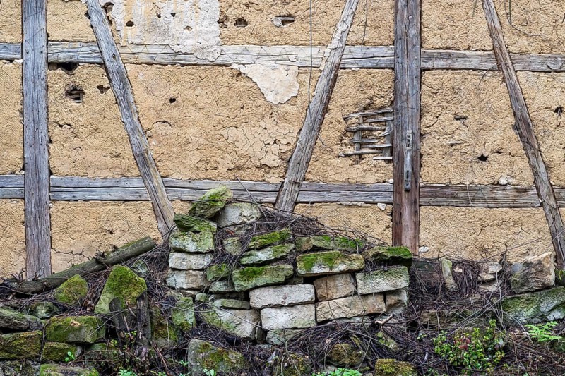 Dilapidated wall and old half-timbered wall