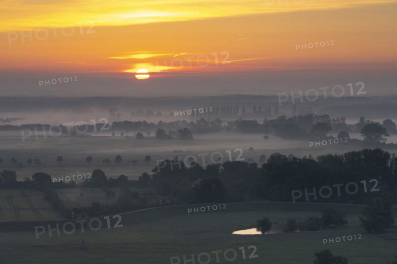 View from the Kniepenberg lookout tower of sunrise and morning fog in the Lower Saxony Elbe floodplain near Neu Darchau