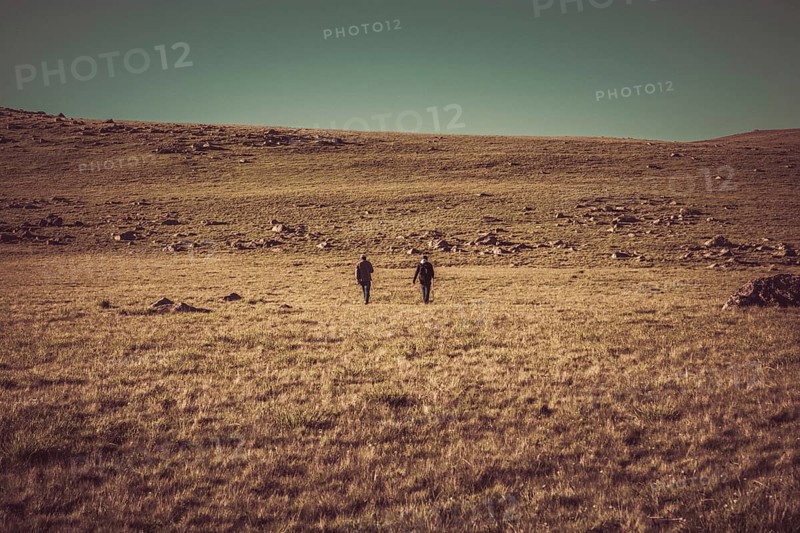 Hikers with backpacks and trekking poles walking in Turkish highland