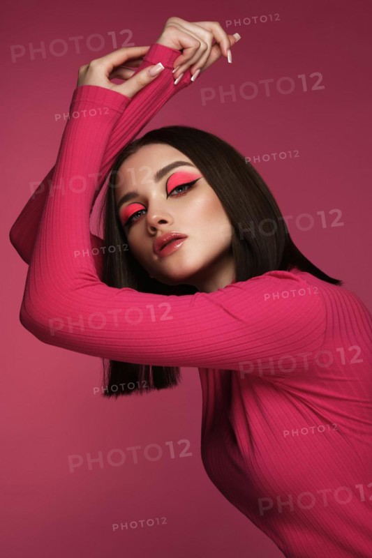 Beautiful brunette woman in pink clothes