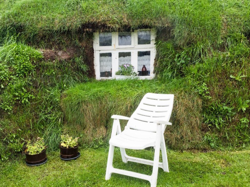 Folding chair in front of window