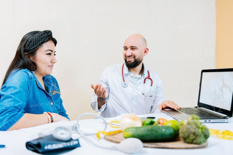 Smiling nutritionist explaining to a female patient
