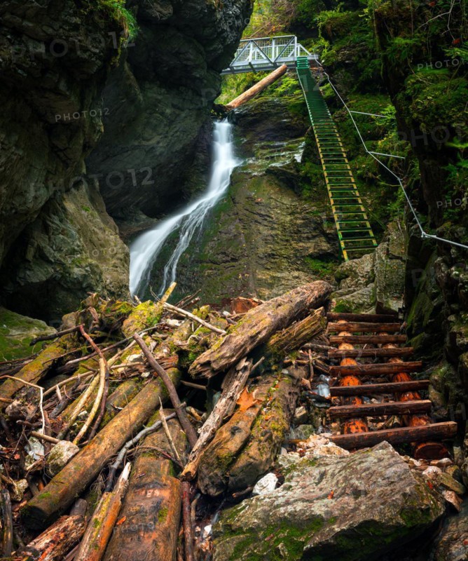 Difficul trail with ladder near the waterfall in canyon of National park Slovak paradise