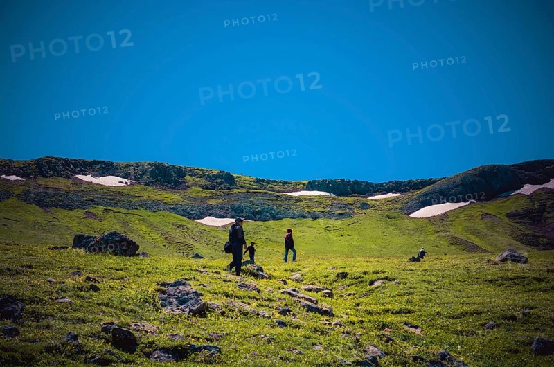 Hikers with backpacks and trekking poles walking in Turkish highland