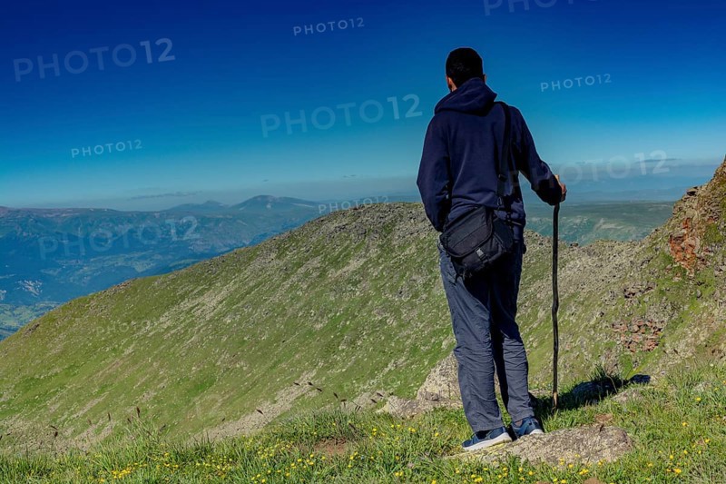 Hikers with backpacks and trekking poles walking in Turkish highland