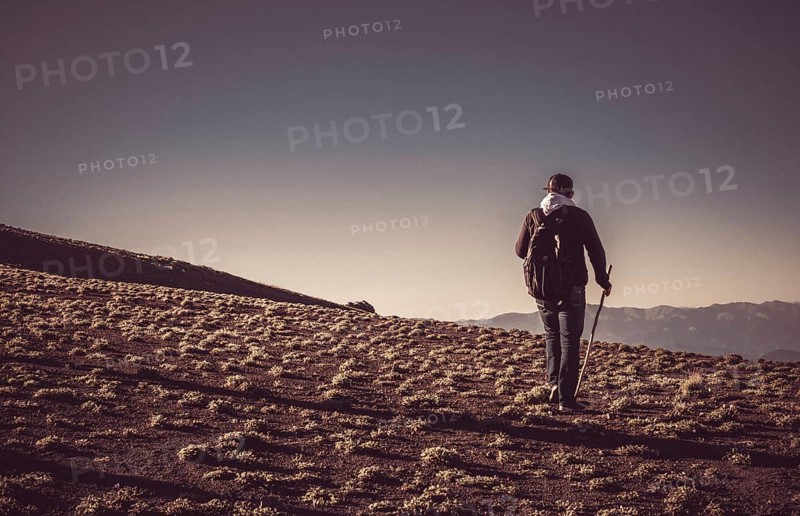 Hikers with backpacks and trekking poles walking in Turkish highland