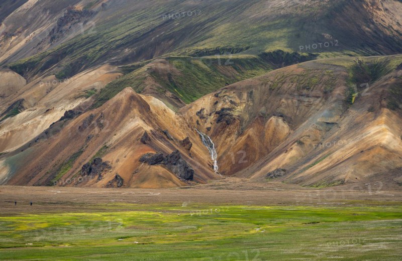 Waterfall between colourful rhyolite mountains