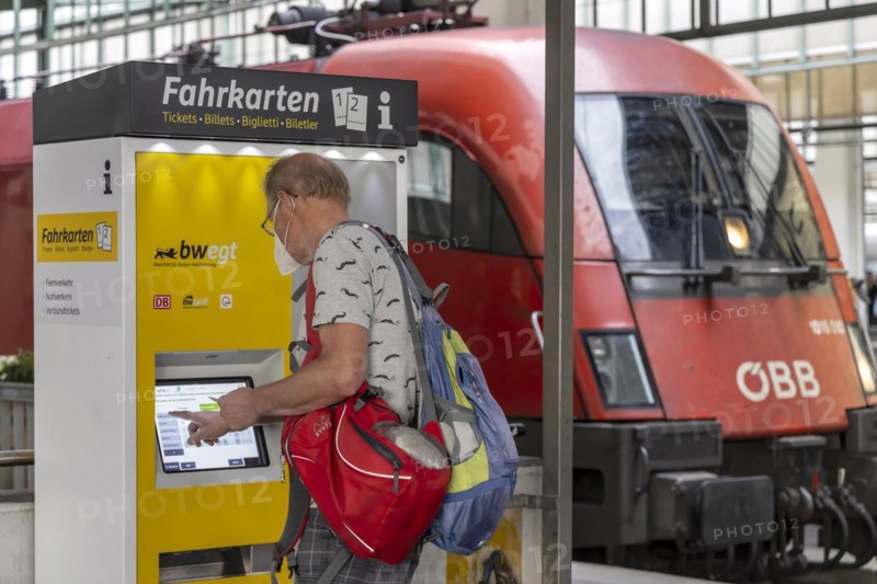 Passenger buys a ticket at the ticket machine