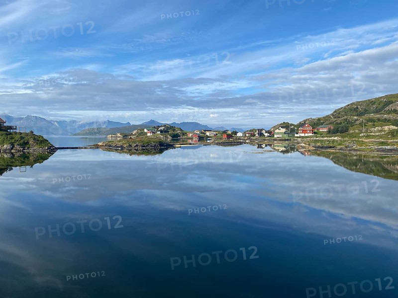 Crystal clear water and wooden houses reflected in the water