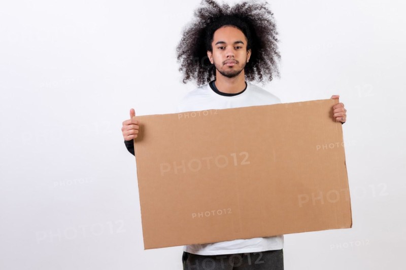 Holding a sign with copy paste space. Young man with afro hair on white background