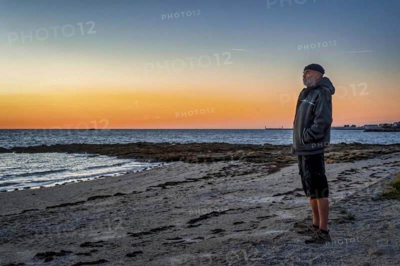 Old man standing on the coast of the Bay of Biscay