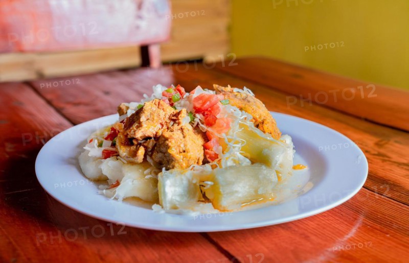 Traditional Chancho dish with Yuca. Nicaraguan pork with yucca served on wooden table