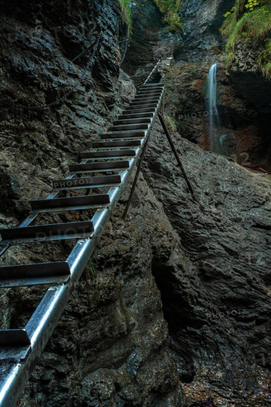 Difficul trail with ladder near the waterfall in canyon of National park Slovak paradise