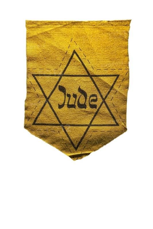 German Jewish badge showing yellow star saying Jude against white background