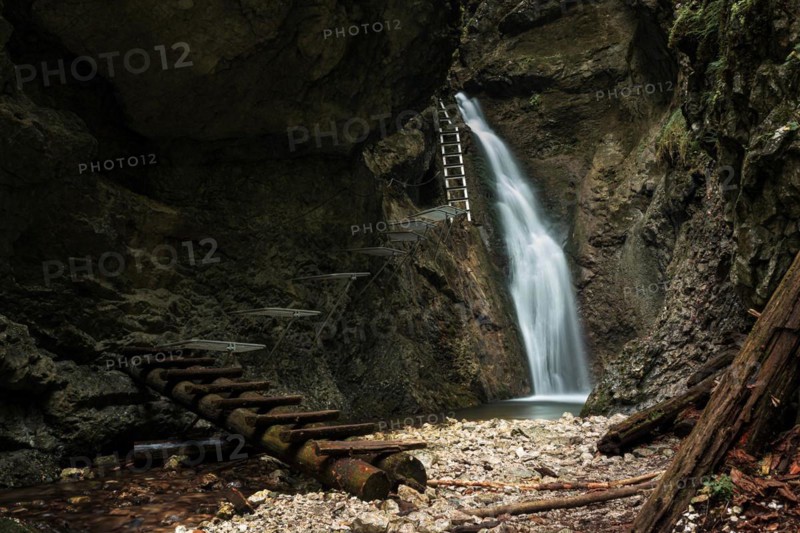 Difficul trail with ladder near the waterfall in canyon of National park Slovak paradise