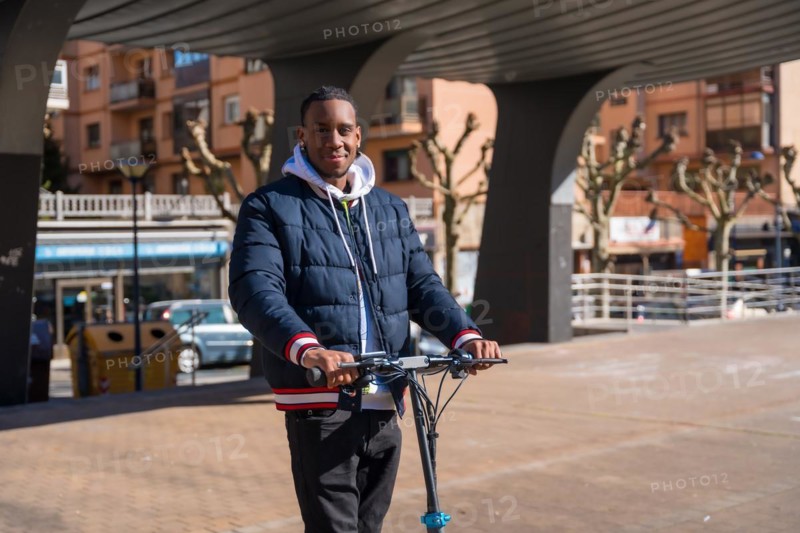 Black ethnic male skateboarding on an electric skate