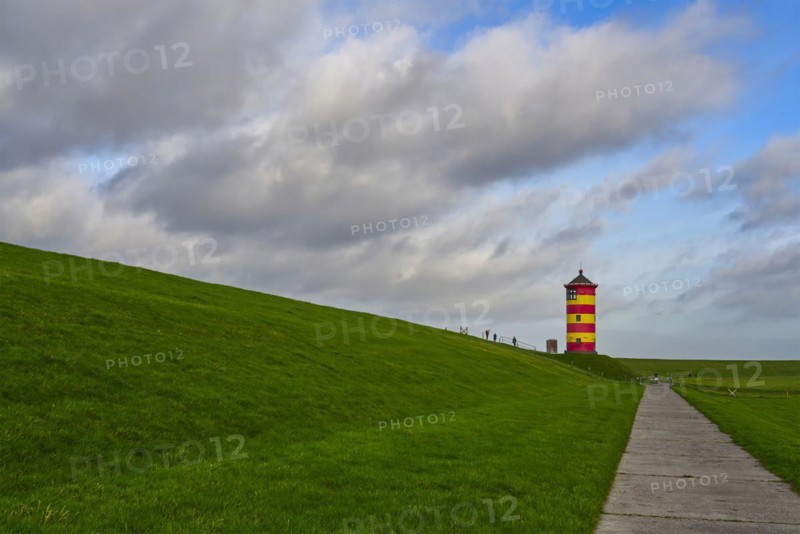 Pilsum lighthouse on the dyke near Greetsiel in the Krummhoern region on the East Frisian North Sea coast