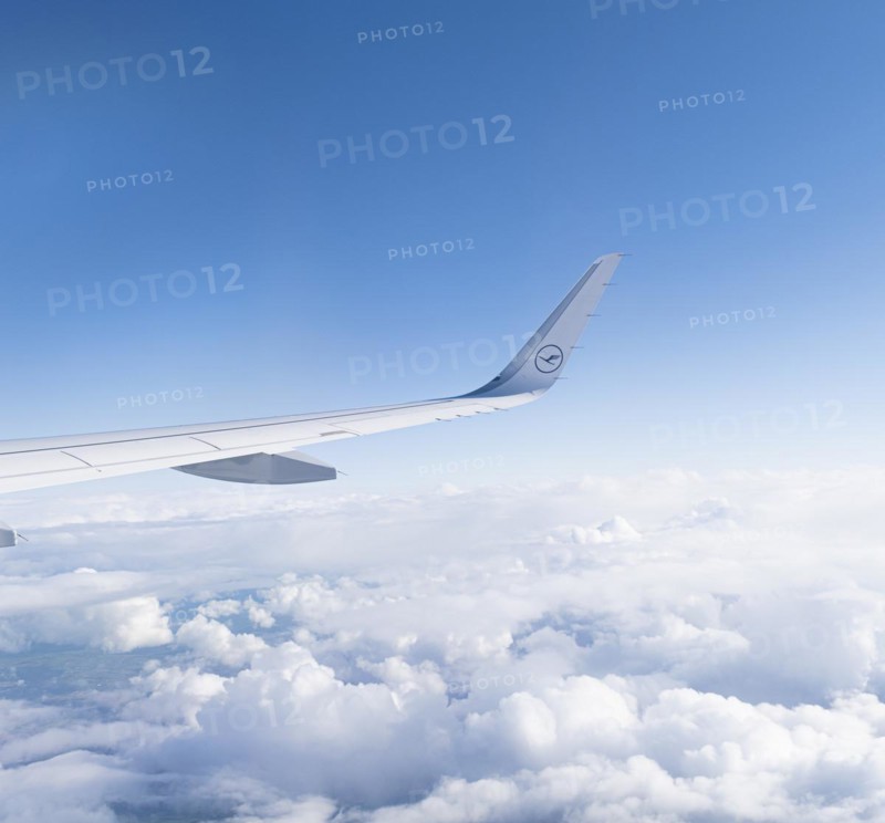 View of the wing of a Lufthansa aircraft over a sea of clouds
