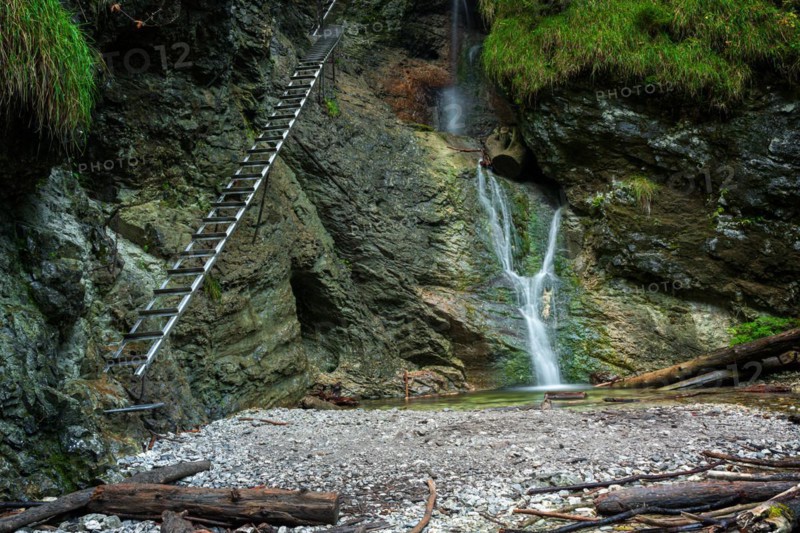 Difficul trail with ladder near the waterfall in canyon of National park Slovak paradise