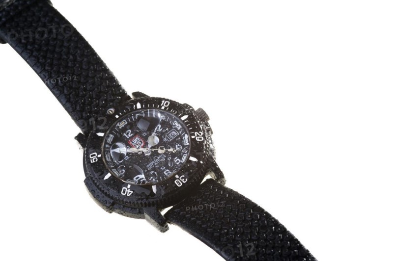 A waterproof wristwatch with water droplets