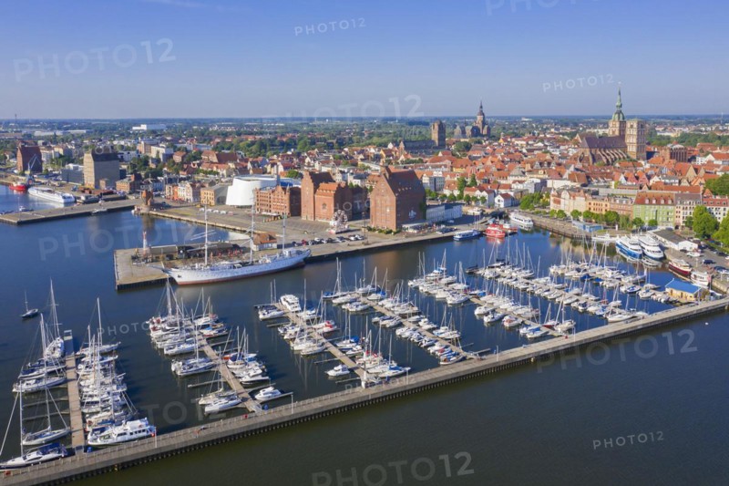 Marina and three-mast barque Gorch Fock docked in the harbour of the city Stralsund along the Strelasund in summer