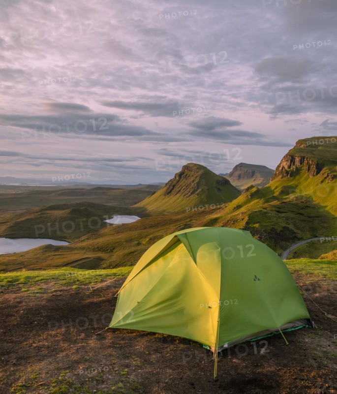 Tent overlooking rocky landscape Quiraing at sunrise