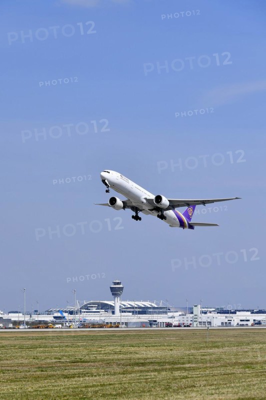 Take-off Thai Airways Boeing B777 Dreamliner with tower in the background