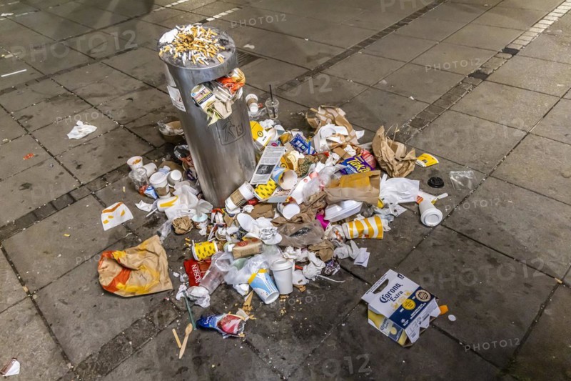 Full waste bins with packaging waste and cigarette butts