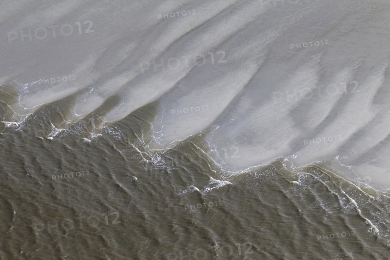 Aerial view of waves breaking on beach at the Schleswig-Holstein Wadden Sea National Park