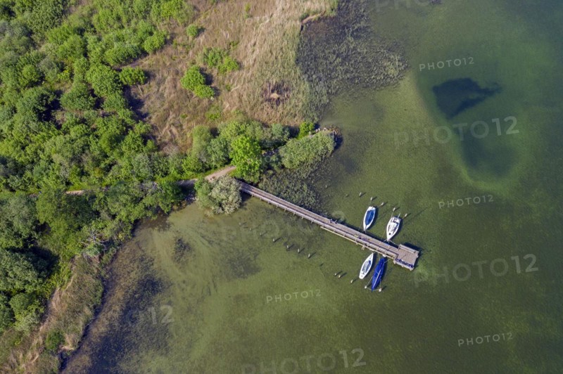 Aerial view over sailing boats moored at wooden jetty in lake Ratzeburger
