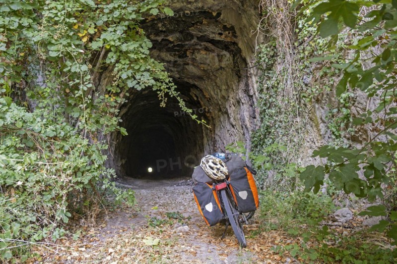 Trekking bike in front of old railway tunnel on the Ciro Trail