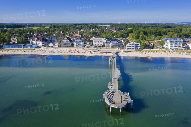Aerial view over wooden pleasure pier and hotels at seaside resort Niendorf along the Baltic Sea