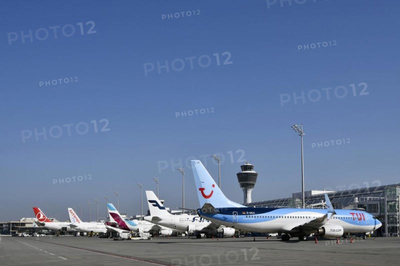 Aircraft on check-in position at Terminal 1 with tower