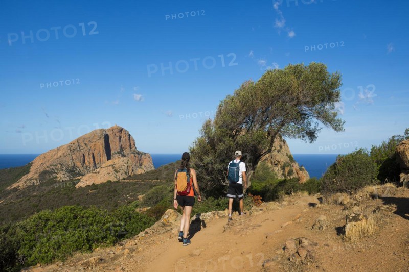 Red granite rocks and hikers