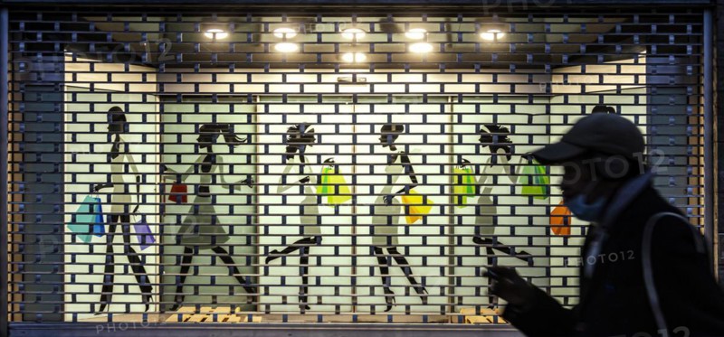 Shop window with roller shutter grille