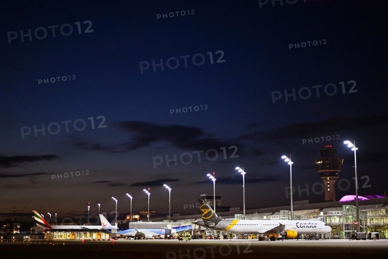 Terminal 1 at night with tower and Condor and TUI fly