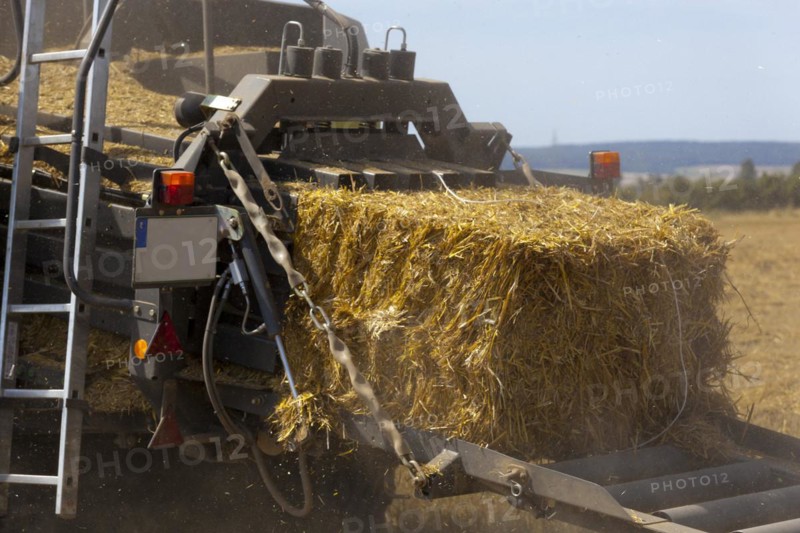 Tractor with a straw baler