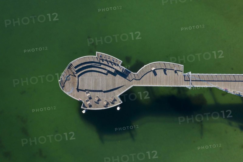 Aerial view over wooden fish-shaped pleasure pier at seaside resort Niendorf along the Baltic Sea
