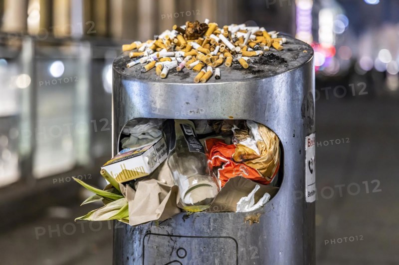 Full waste bins with packaging waste and cigarette butts